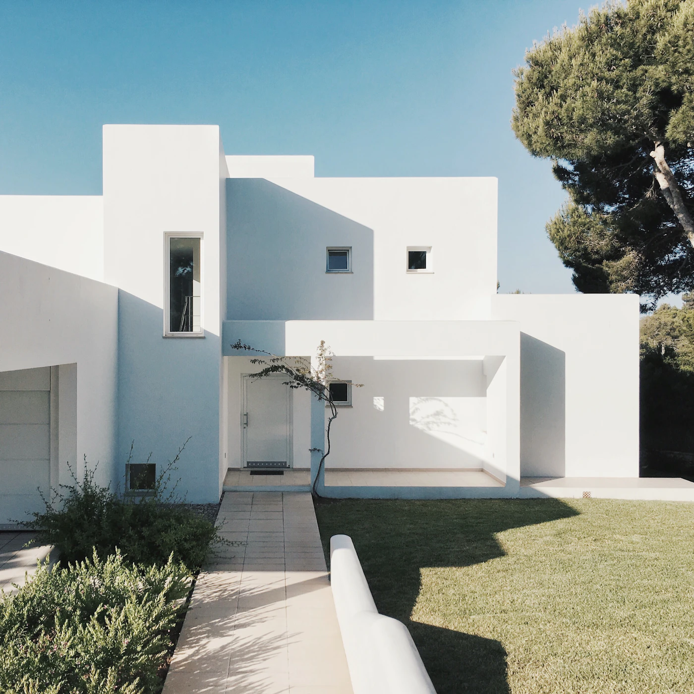 Minimal white contemporary home against a clear sky