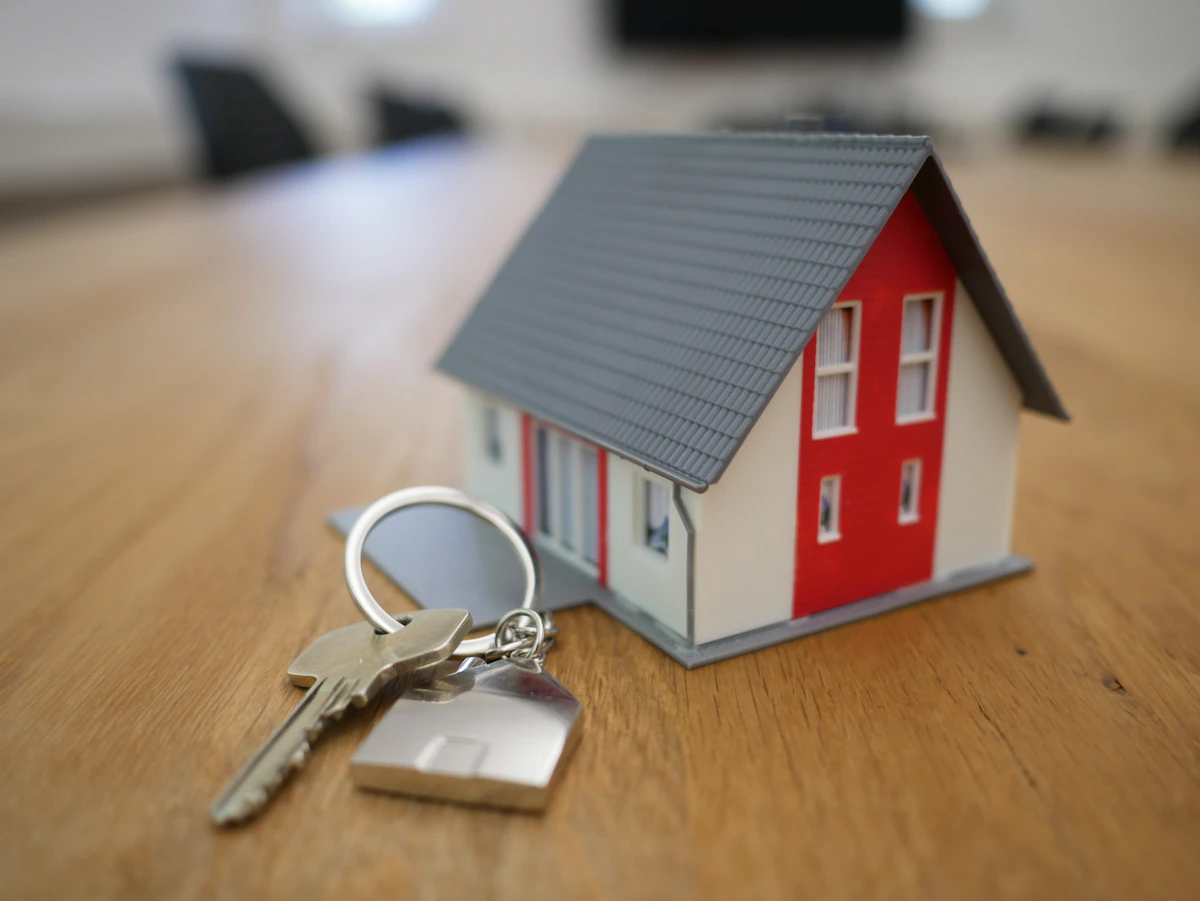 House keys resting on a scale model home